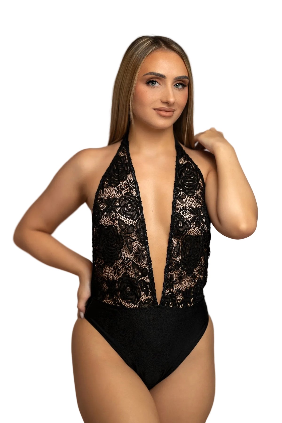 A woman models the High Waist Halter One Piece by Brigitewear International, LLC, posing confidently on a sandy beach with the ocean in the background.