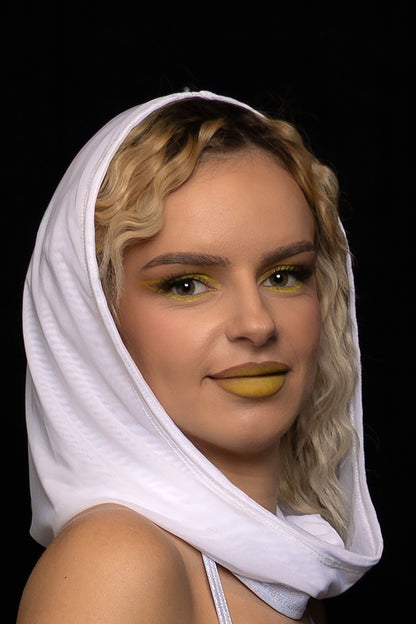 A woman with wavy blonde hair and yellow makeup wears the Brigitewear International, LLC White Mesh Hood, posing against a black background.