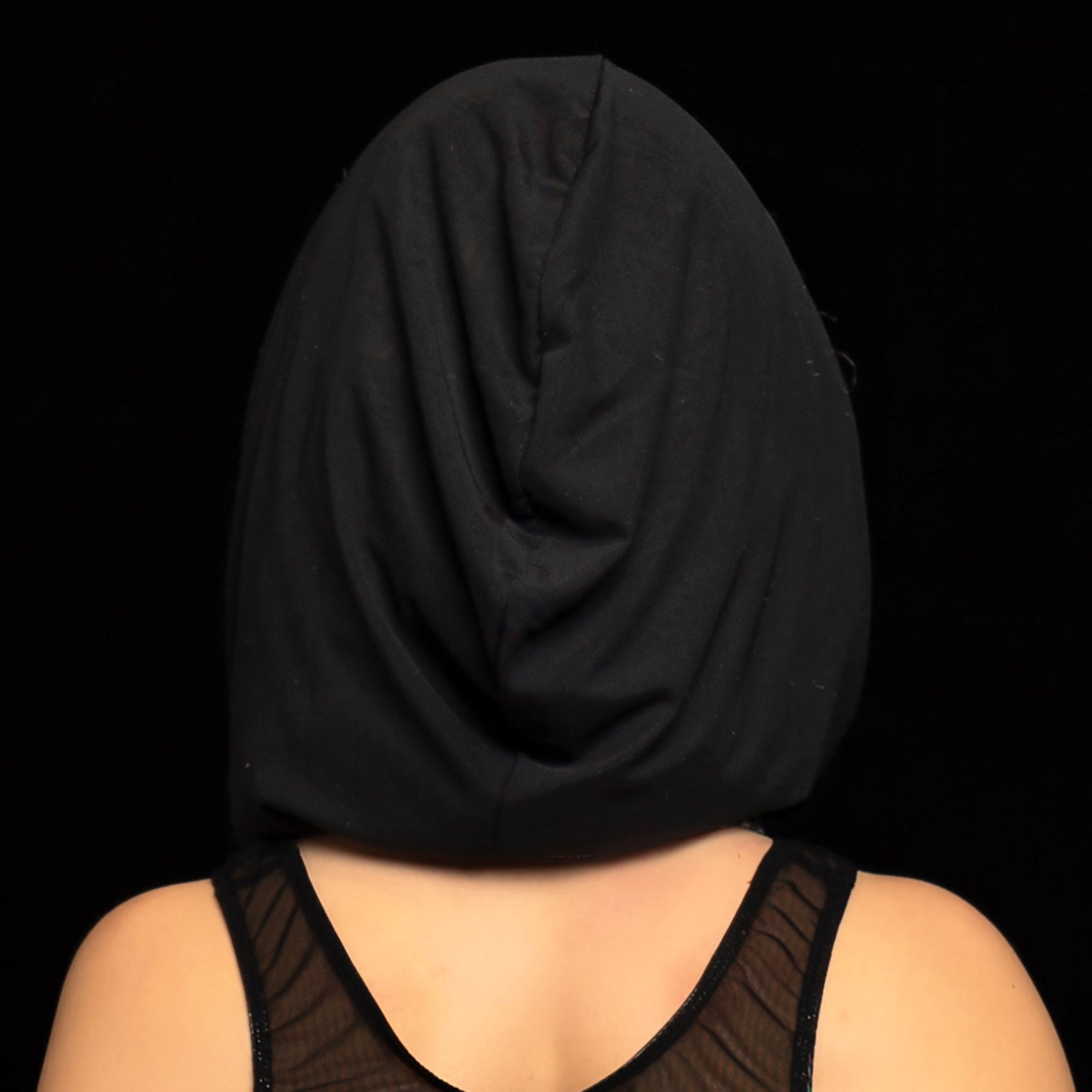 A model wears the Brigitewear International, LLC Black Mesh Hood and a sleeveless black mesh top against a black background.