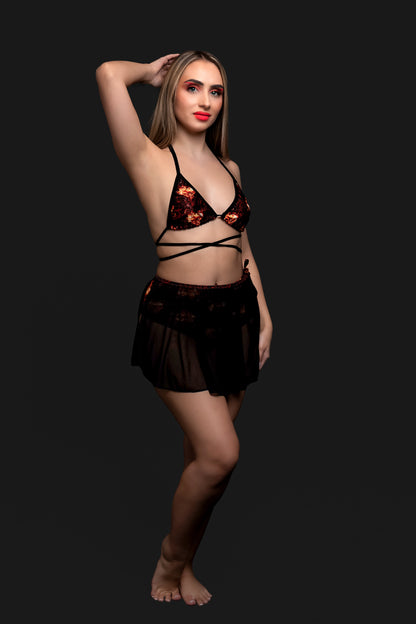 Model wears the Brigitewear International, LLC Inferno Heart Triangle Top with a sheer skirt, posing against a plain black background.