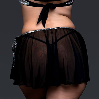 Model in sheer black Electric Glint rave swimwear by Brigitewear International, arms raised and seen from behind against a dark background.