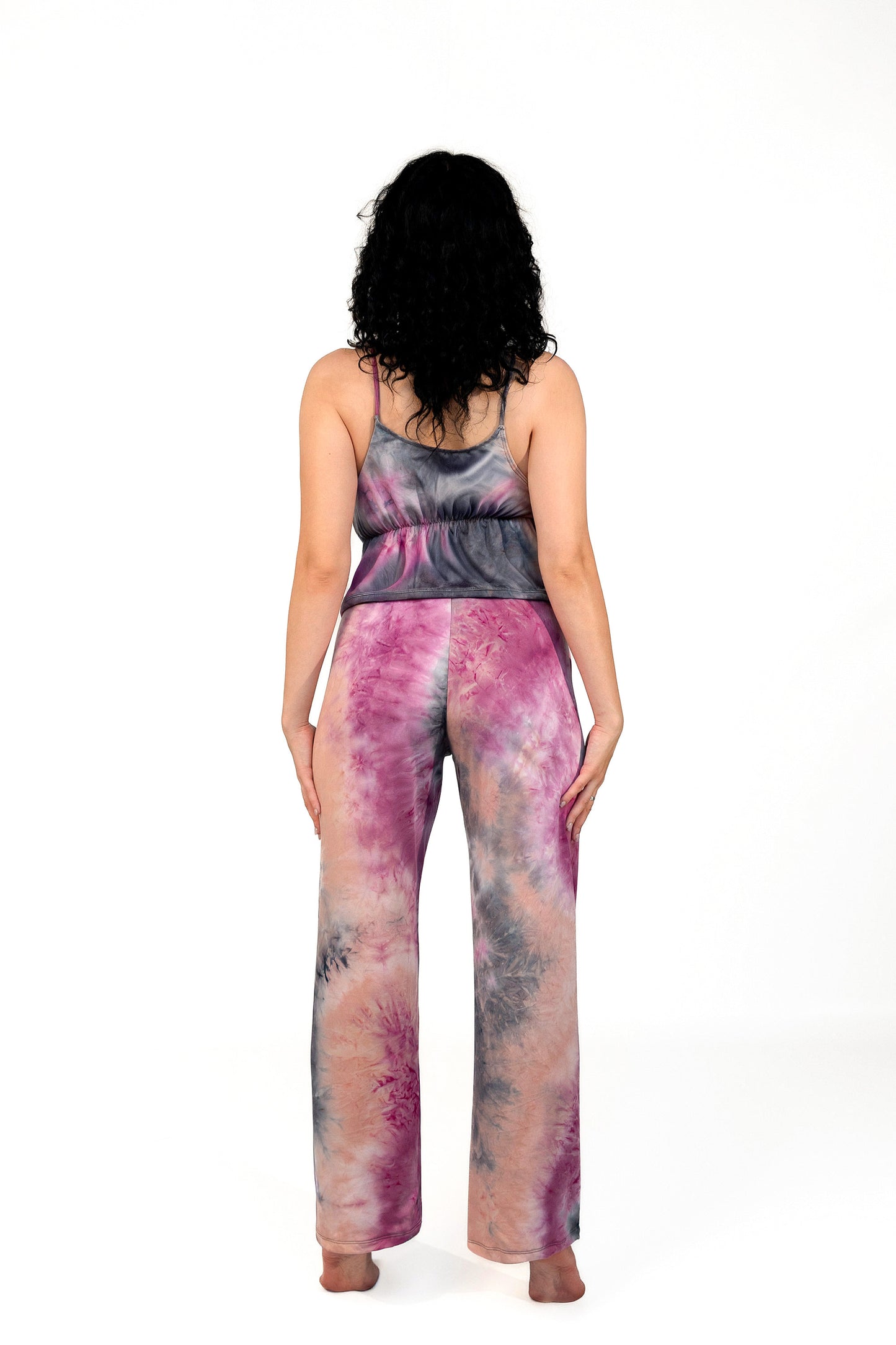 Woman with curly hair stands barefoot, facing away, wearing the Brigitewear International Long Loungewear Top-Soft & Cozy.