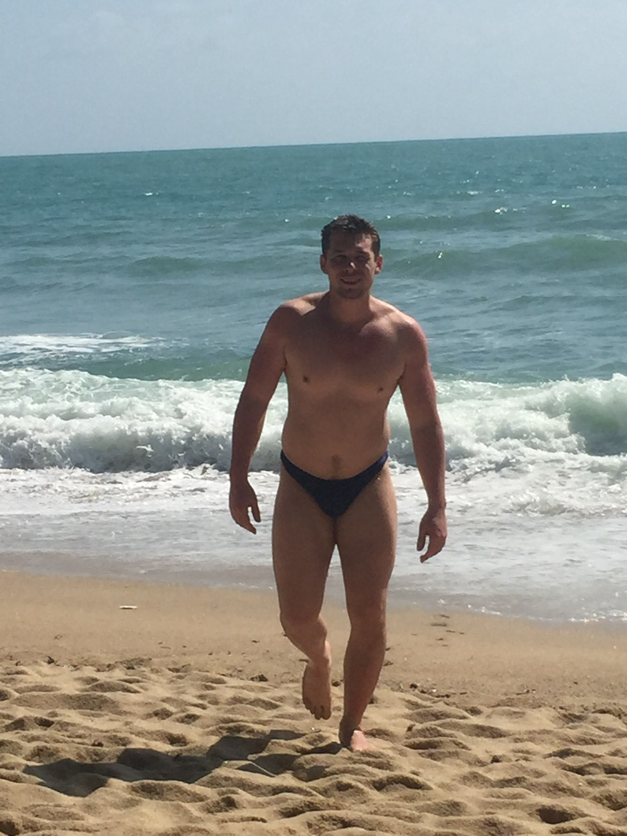 Men’s beach swimwear – black bikini swim briefs at the shore