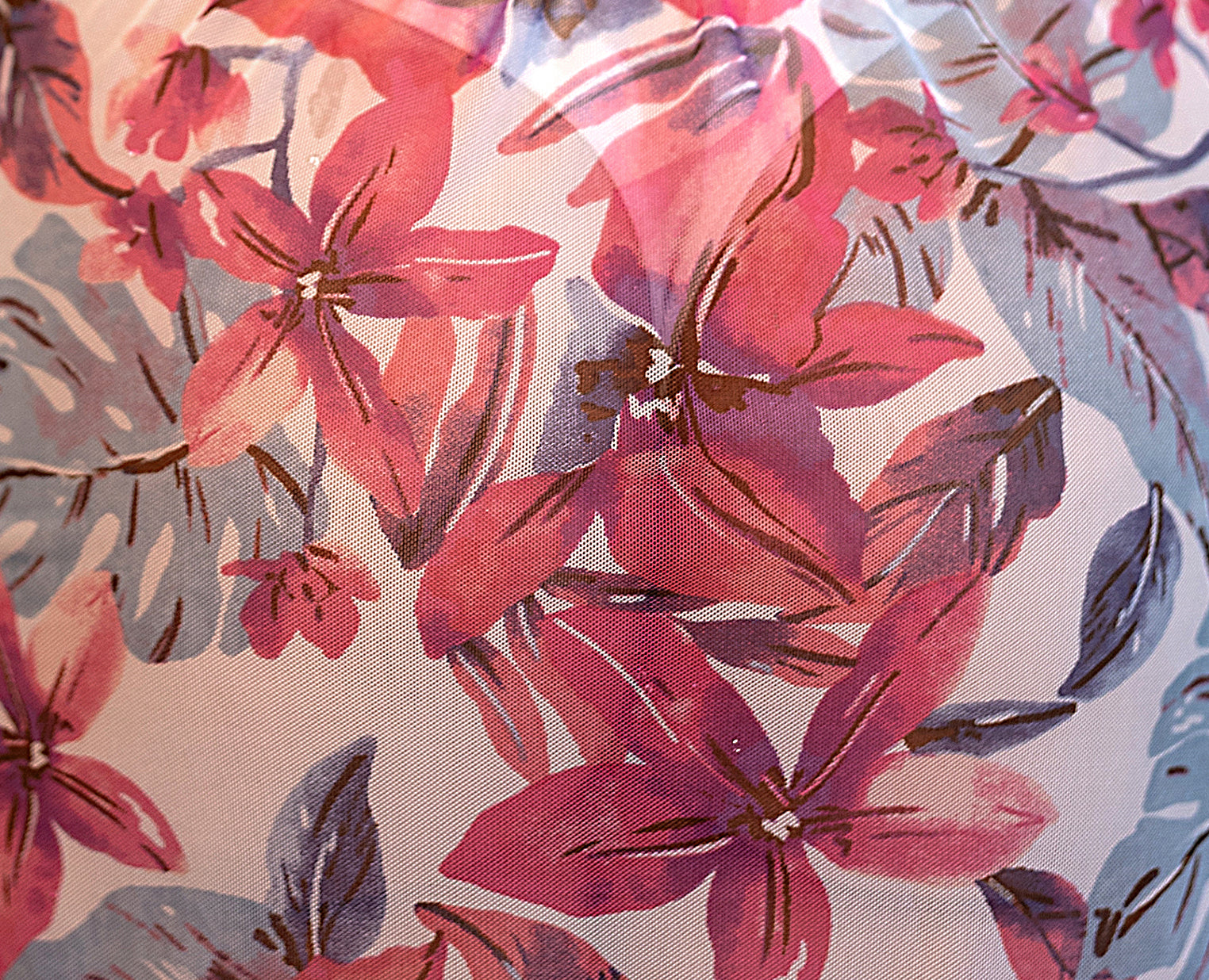Pink floral mesh fabric with red flowers and purple leaves on a light background