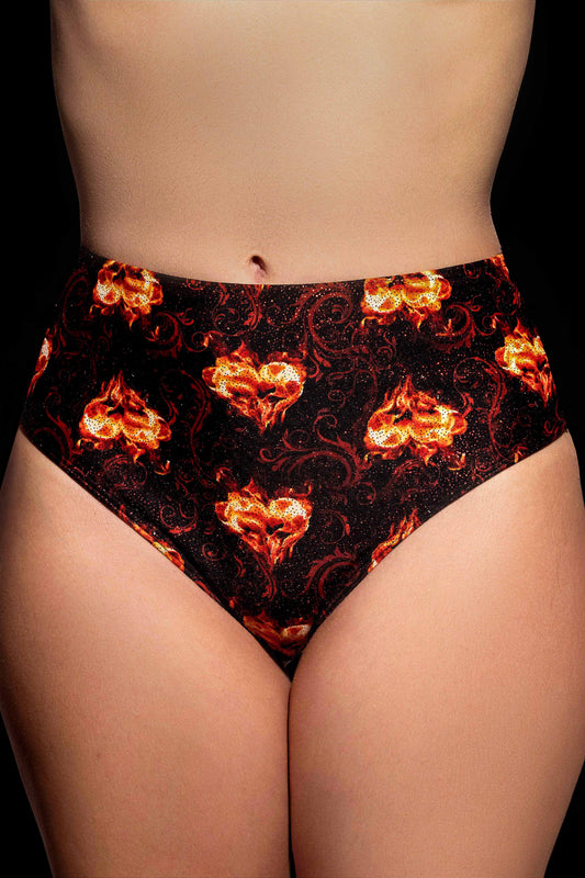 Someone wearing Brigitewear International, LLC's Inferno Heart High Waist Bottoms, featuring a bold black design with red and orange flame patterns.