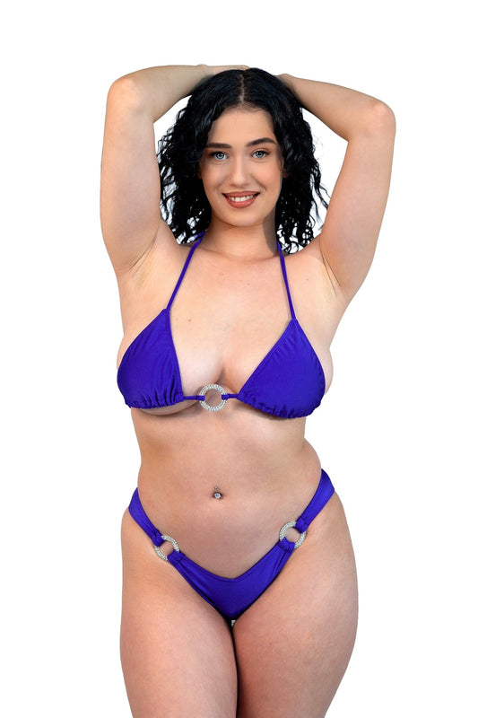 Smiling woman with curly dark hair poses in the Cannes Ring Top by Brigitewear International, LLC, hands behind her head.