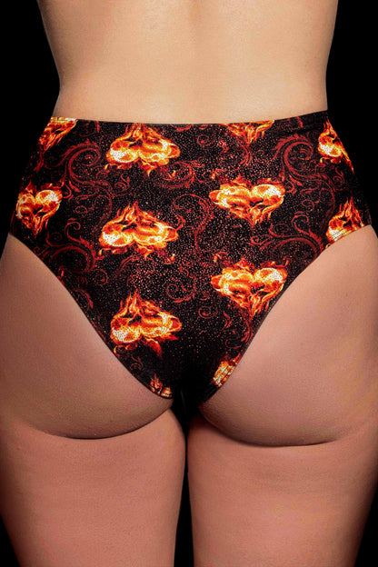 Back view of a person wearing Brigitewear International, LLC’s Inferno Heart High Waist Bottoms featuring a fiery flame design on black.