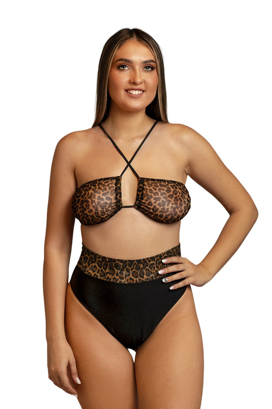 Model wearing the Dynamic Bandeau Top by Brigitewear International, LLC, smiling with one hand on her hip against a white background.