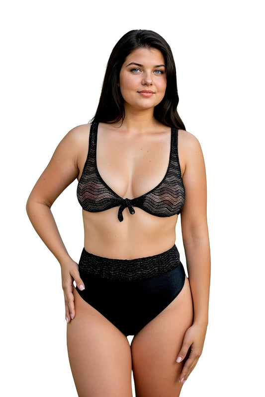 A woman models Brigitewear International, LLC’s High Waist Bottom Wavy Mesh Fabric bikini featuring a black sheer wavy-patterned top and high-waisted bottoms, standing against a white background.