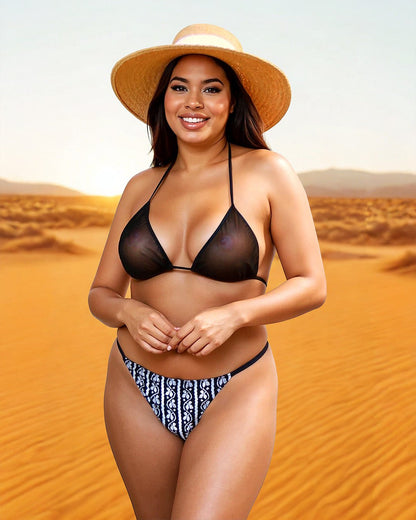 Smiling woman in a sun hat models the Inferno G-string Bottom by Brigitewear International, LLC in a sunny desert setting.