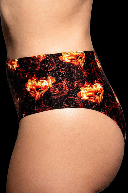 Model wears Brigitewear International’s Inferno Heart High Waist Bottoms in black, featuring a red and orange flaming heart pattern—side view.