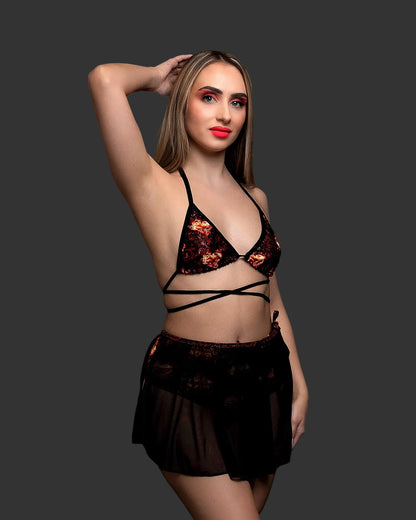Woman wearing an Inferno Heart Triangle Top-Rave Festival black bikini with red flames and a matching sheer sarong.