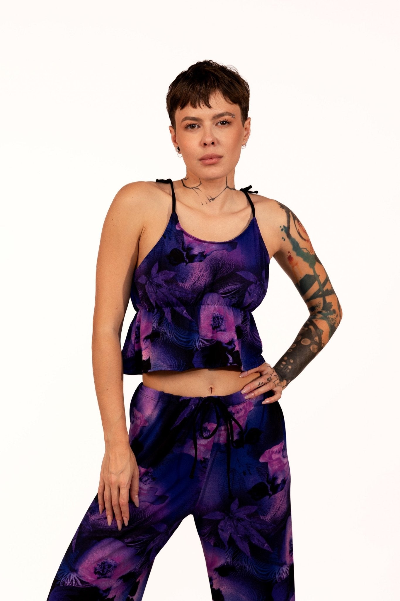 Model wearing the Long Loungewear Top-Soft & Cozy by Brigitewear International, LLC poses against a plain white background in a purple floral design with matching pants.