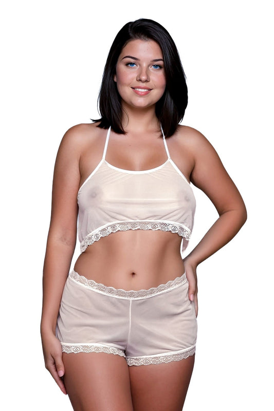 Woman wearing Brigitewear International's Malibu Nights Boy Shorts set, featuring a sheer white lace-trimmed crop top and shorts, standing and smiling against a white background.