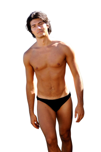 A young man models the Brigitewear International, LLC Speedster Men’s Swimsuit – Classic European Style Swim Brief against a white background.