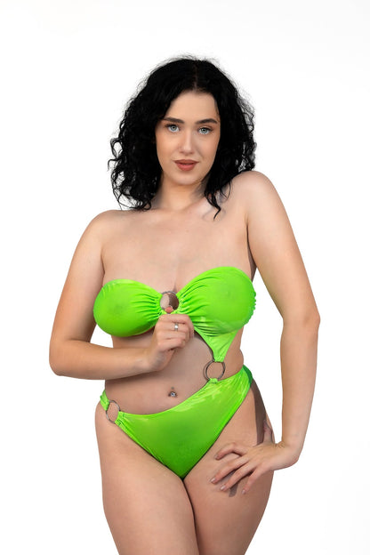 Woman with curly black hair wearing the Tri-Ring Rio Swimsuit by Brigitewear International, LLC in bright green, standing against a white background.