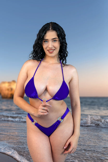 A woman wearing Brigitewear International's V-Bottom Thong & Rio Bikini Bottoms stands in the water.